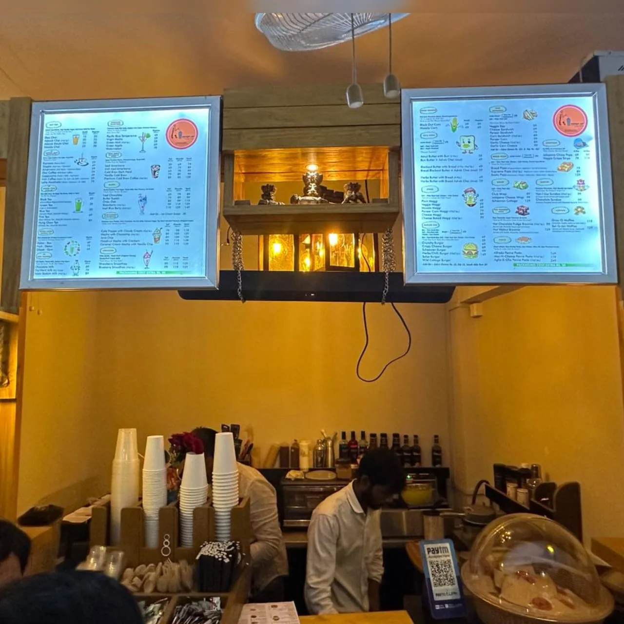 Ancient Sip café interior with menu boards and a service counter