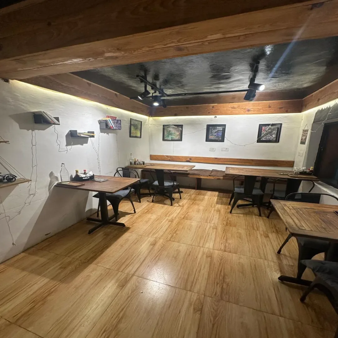 Ancient Sip café dining room with a central indoor tree