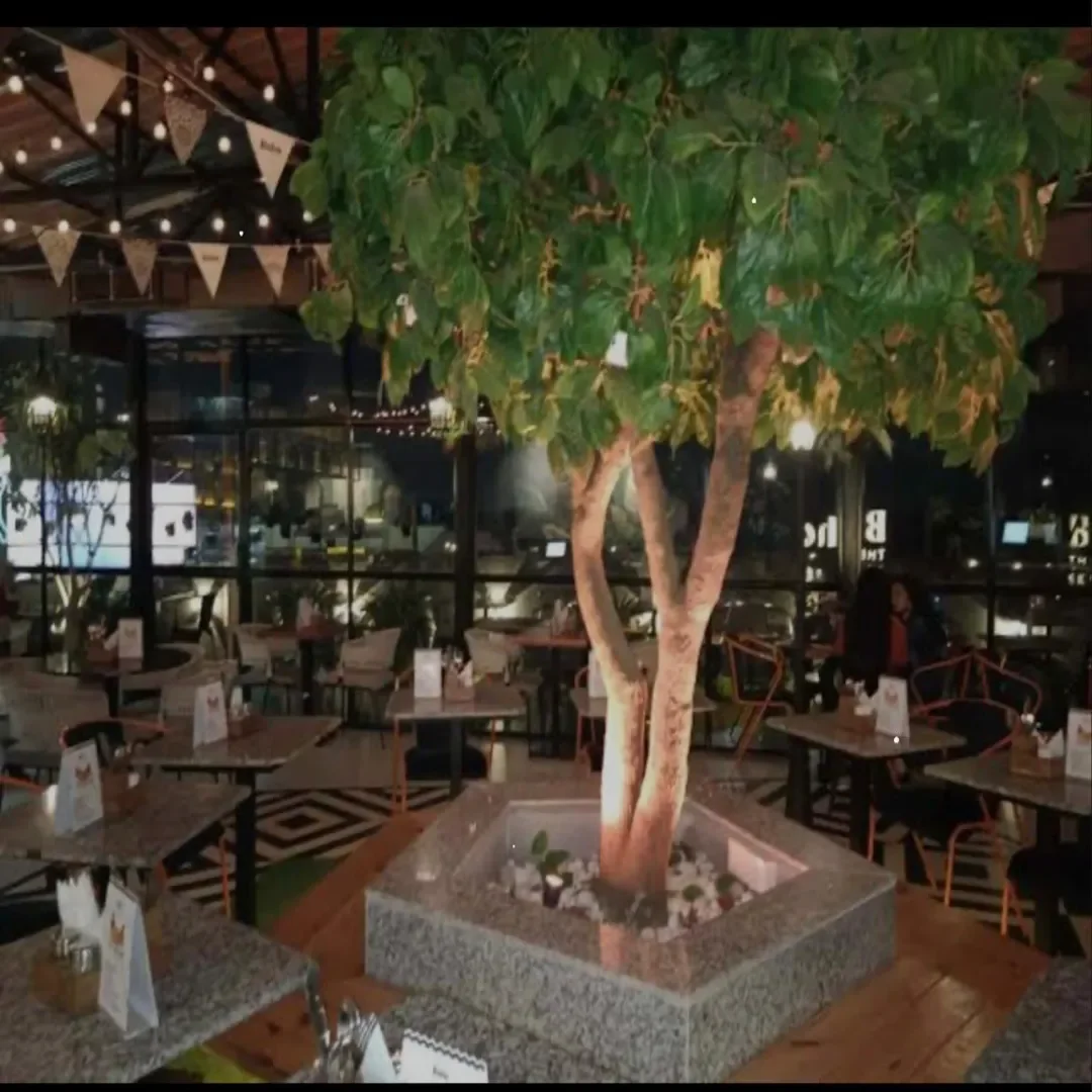 Ancient Sip café seating area with wooden tables and framed wall art