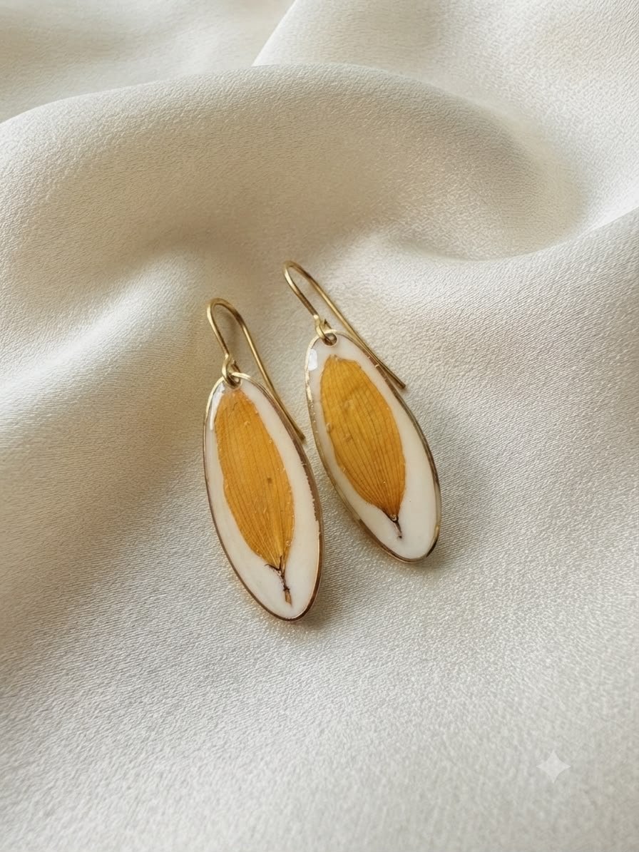 Oval resin earrings with pressed yellow leaves