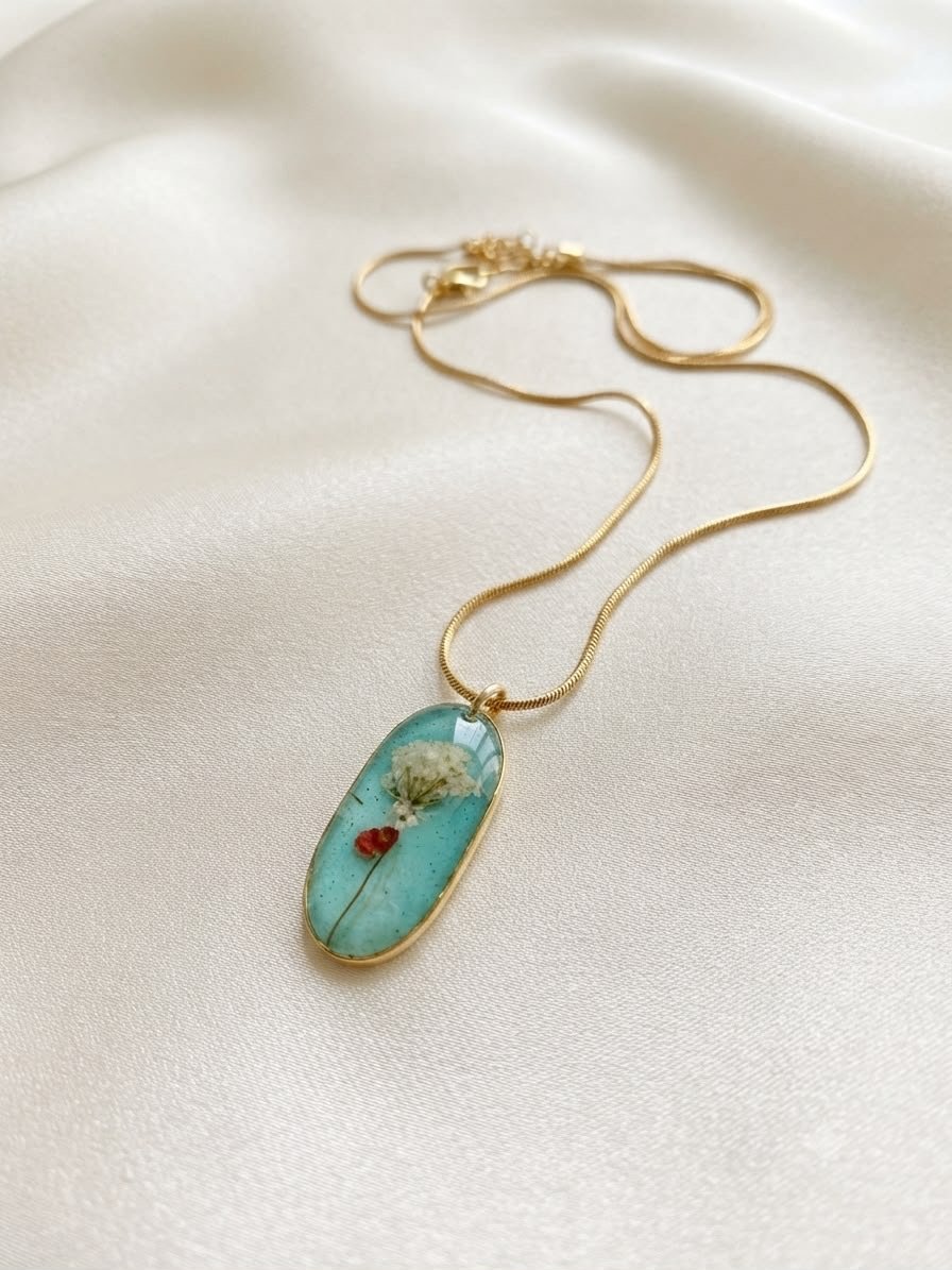 Turquoise resin necklace pendant with tiny pressed flowers